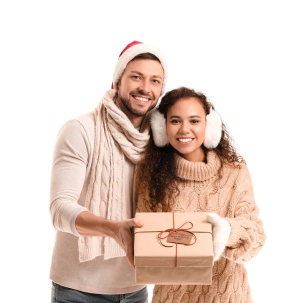 Happy couple with Christmas gift on white background - Фото, изображение