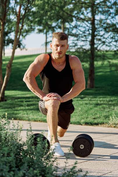 athletic man with dumbbells workout outdoors motivation - Foto, Imagen