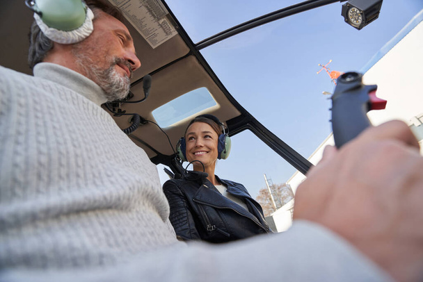 Lovely woman and her man enjoying a helicopter flight together - Fotoğraf, Görsel