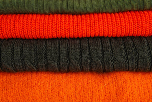Stack of different stylish sweaters as background - Photo, Image