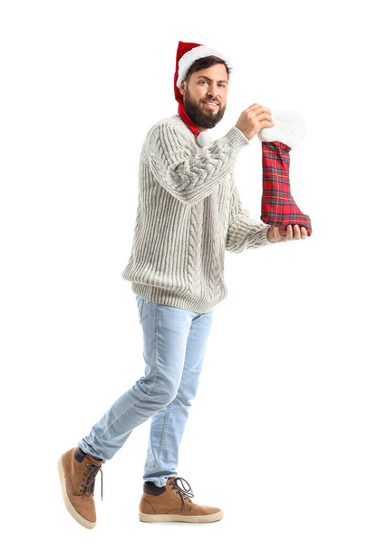 Walking man with Christmas sock on white background - Foto, immagini