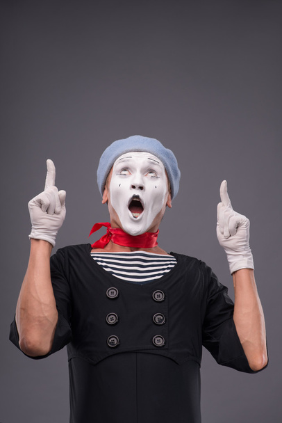 Portrait of male mime with grey hat and white face grimacing wit - Fotografie, Obrázek