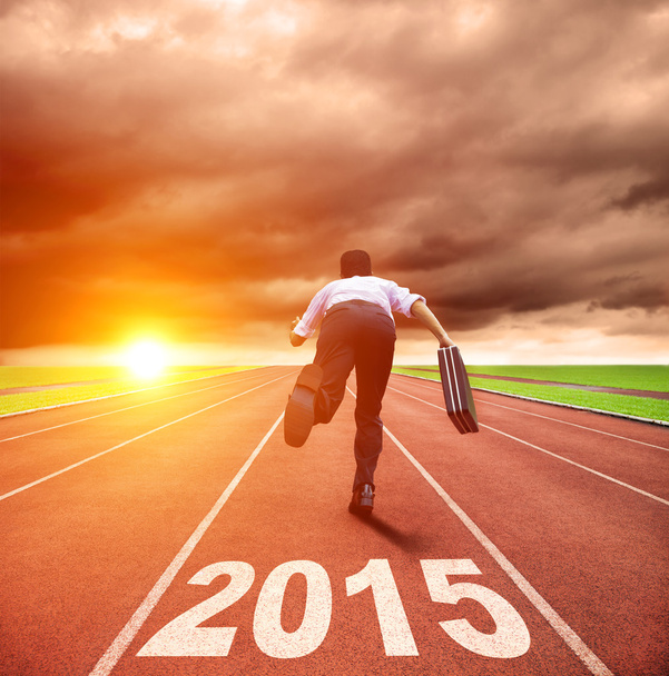 happy new year 2015. businessman running with sunrise background - Photo, Image