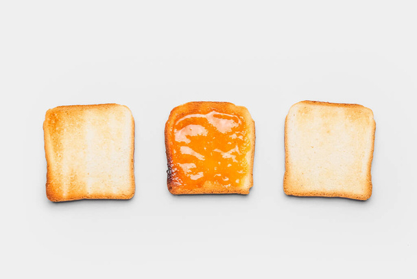 Tasty toast with tangerine jam on white background - Photo, image