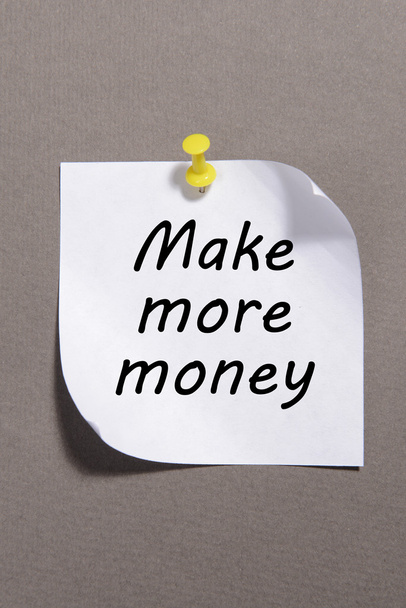 Paper sheet with inscription "Make more money" on grey background - Fotó, kép