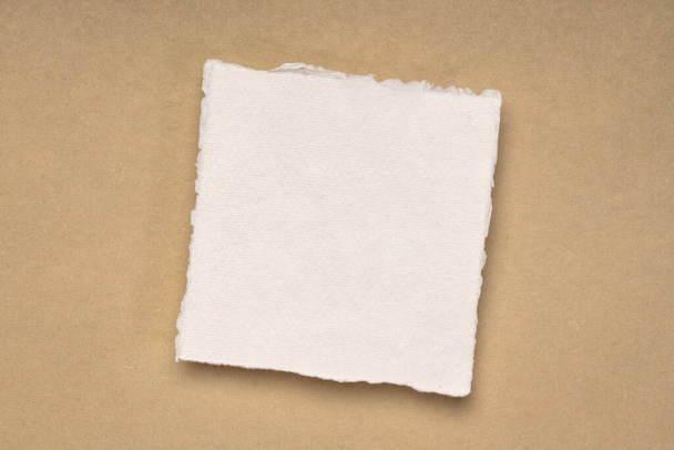 small square sheet of blank white Khadi paper against beige rag paper - Foto, Imagem