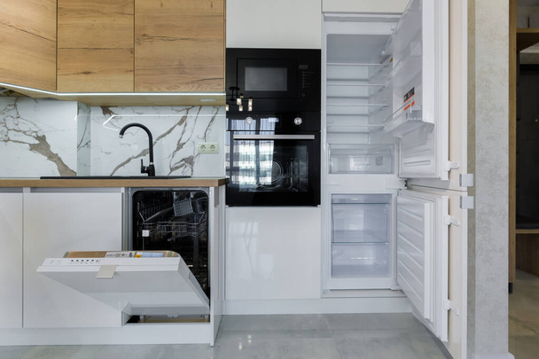 Kitchen room with open refrigerator and dishwasher interior - 写真・画像