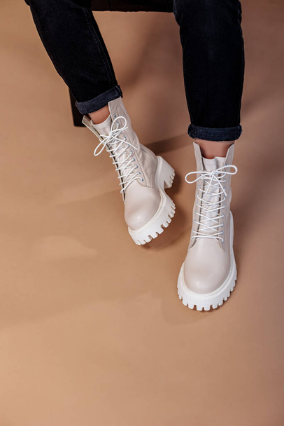 Young woman in beige stylish fashionable leather lace-up shoes. Fashionable collection of women's autumn shoes. Close-up of female legs in shoes. - Photo, Image