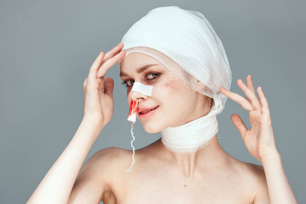 emotional woman bandaged face health problems studio lifestyle - Fotoğraf, Görsel