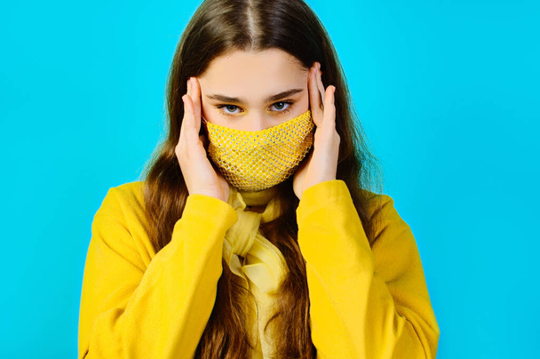 beauty portrait of a teenage girl in a glamorous yellow mask with rhinestones - Φωτογραφία, εικόνα