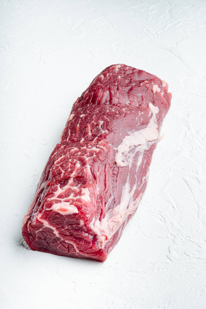 Gourmet portion of raw fresh marbled beef fillet set, on white stone  background, with copy space for text - Photo, Image