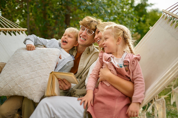 Cheerful family having fun on hammock, camping - Fotografie, Obrázek