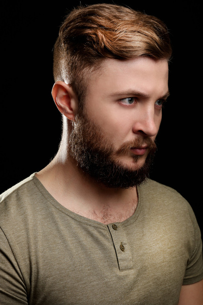 Portrait of handsome man with beard on black background - Foto, Imagem