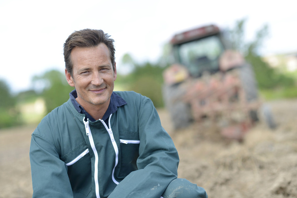 Smiling farmer in cultivated land - Фото, зображення