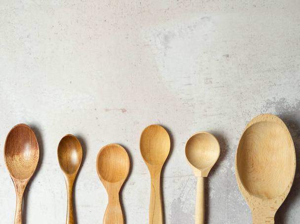 Wooden spoons made of natural wood on a light background. Natural natural materials. Caring for the environment - Photo, Image