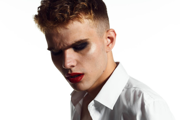 guy in female cosmetics white shirt posing homosexual light background - Valokuva, kuva