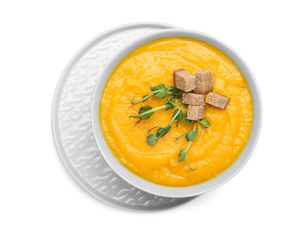 Bowl of tasty pumpkin cream soup on white background - Photo, Image