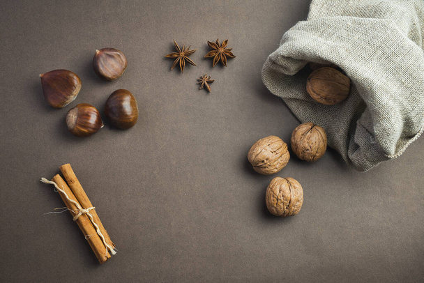 Walnuts, anise, cinnamon. Autumn and winter ingredients. Healthy food and cooking concept - Foto, Imagem