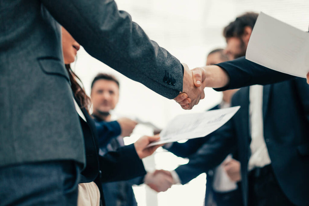 group of employees shaking hands at an office meeting. - Photo, Image