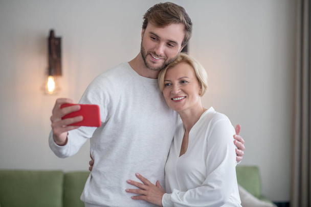 Young bearded man making selfie with his mom - Φωτογραφία, εικόνα