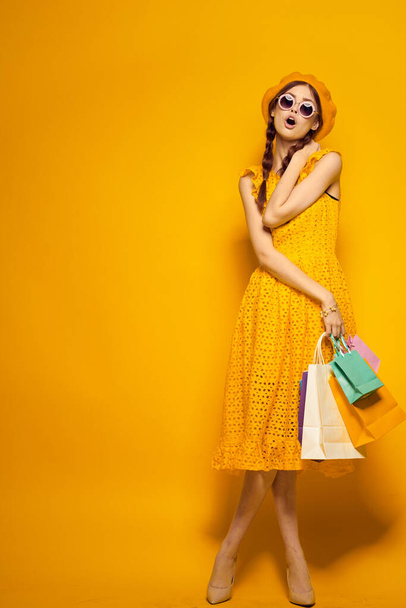 smiling woman in a yellow hat Shopaholic fashion style isolated background - Photo, Image