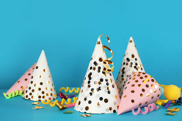 Many party hats and festive items on light blue background - Photo, Image