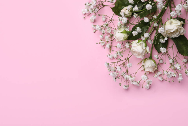 Beautiful white gypsophila and roses on pink background, top view. Space for text - Photo, Image