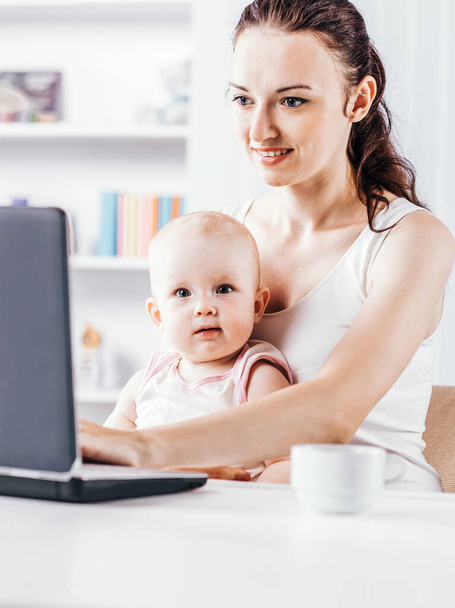 young mother and baby using laptop to communicate with grandma v - Zdjęcie, obraz