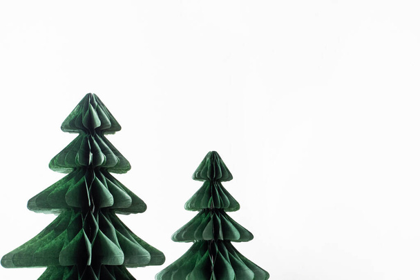 Trendy decorative Christmas trees, which made of paper with blurred house background, DIY project, Organic Modern Design, Hanging Festive Honeycomb Foldable 3D tree - Foto, Imagem