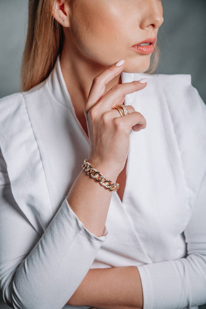 women's accessories. women's gold bracelet on the girl's hand - Fotografie, Obrázek