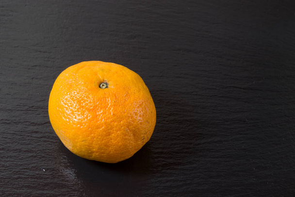 ripe tangerine on the table - Φωτογραφία, εικόνα