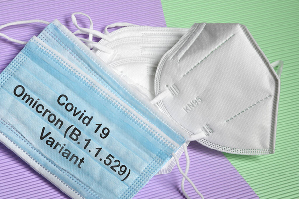 antiviral and ffp2 medical masks for protection against coronavirus with text Covid 19 Omicron Variant. COVID-19 omicron variant strain protection concept. - Photo, Image