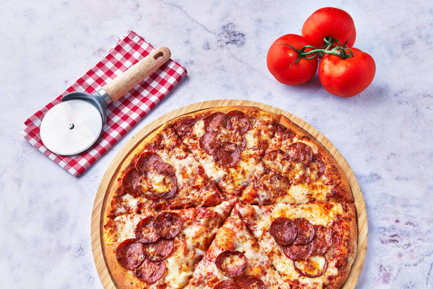  Delicious pepperoni italian pizza on a marble surface - Photo, Image