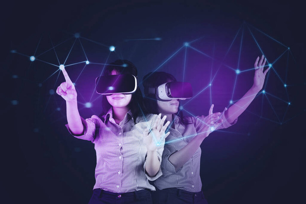 Young woman using a virtual glasses while playing in the metaverse with connection network background - Фото, зображення