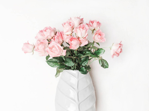 Bouquet of pink roses in ceramic vase. Floral still life with roses on white background. Front view - Photo, Image