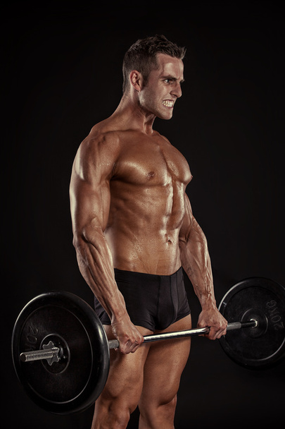 bodybuilder τύπος κάνει ασκήσεις με μεγάλο αλτήρα - Φωτογραφία, εικόνα