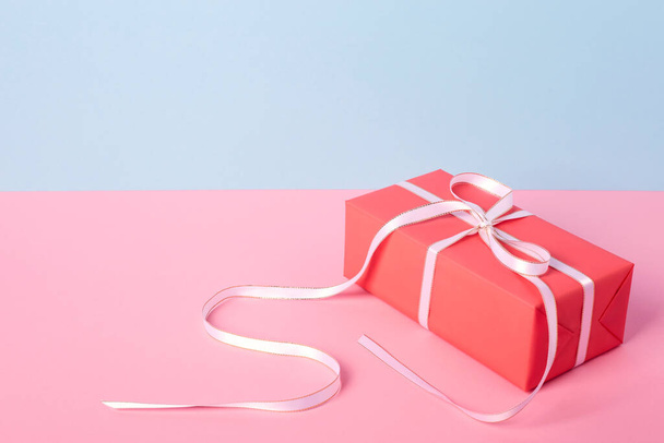 Gift in bright packaging. Pink-blue background - Photo, Image