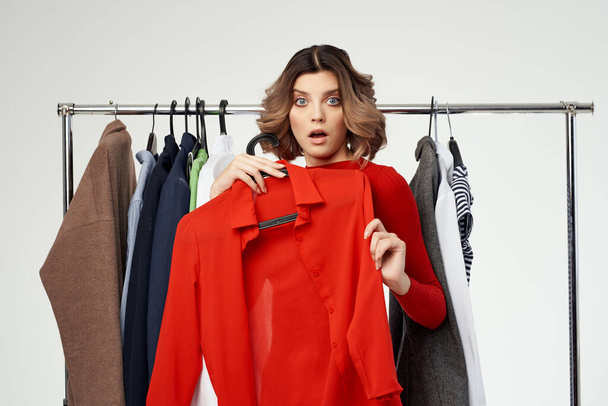 cheerful woman trying on clothes on  isolated background. High quality photo - Photo, Image