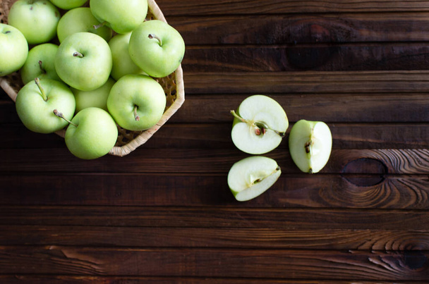Lots of ripe green apples on a wooden background. - Fotó, kép