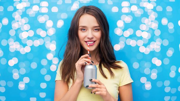 young woman or teenage girl drinking soda from can - Photo, image
