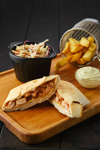 Tostada with chicken fillet served with cabbage salad and american fries on wooden tray - Foto, Imagem