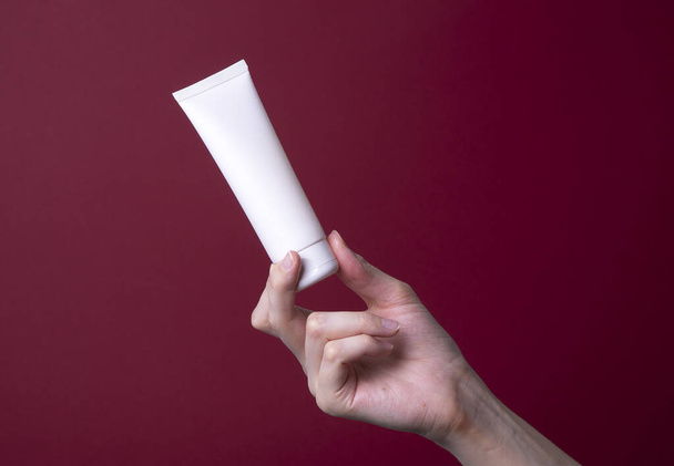 packaging of hand cream in female hands - Fotó, kép