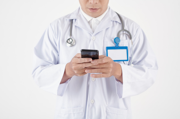 General Practitioner Reading Text Messages - Photo, Image