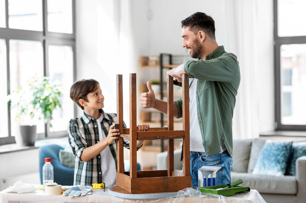 father and son sanding old table with sponge - Zdjęcie, obraz