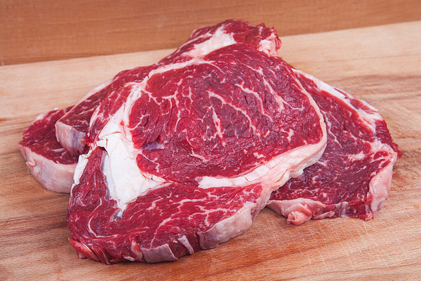 Fresh raw beef steak on wooden background. Roast beef. - Photo, Image