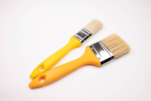 clean brushes lie on a white background. Construction. Tools for building houses and apartments - Foto, Bild