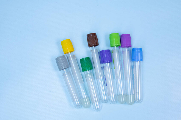 Vacuum tubes for collection and blood samples on blue background with sodium citrate EDTA heparin fluoride anticoagulant for laboratory  - Zdjęcie, obraz