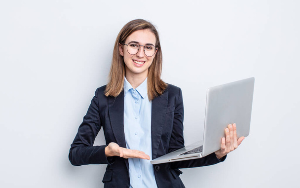 businesswoman young pretty woman smiling cheerfully, feeling happy and showing a concept. business and laptop concept - Foto, afbeelding