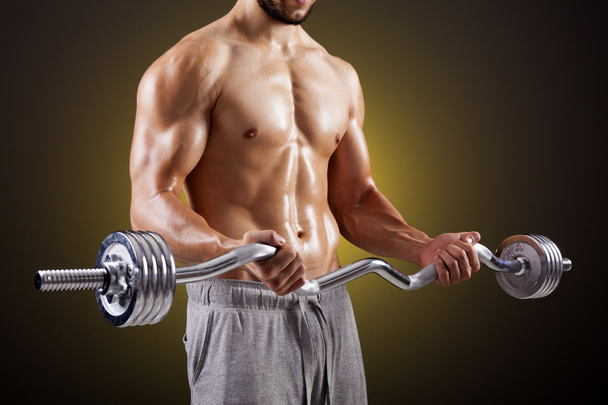 Fitness man lifting weights with curl bar - Zdjęcie, obraz