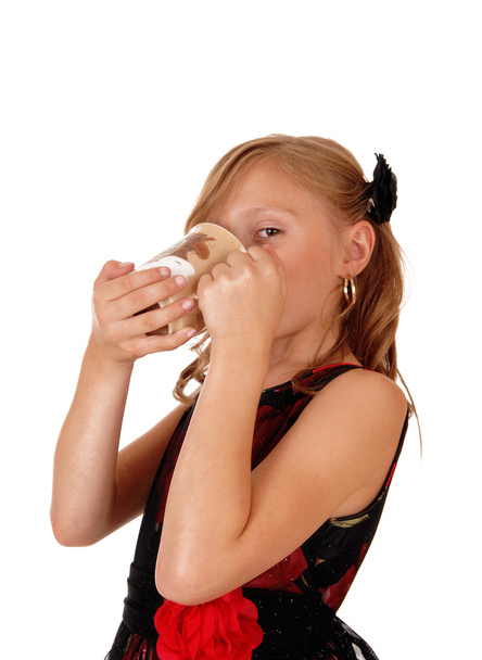 Girl drinking from a mug. - Zdjęcie, obraz